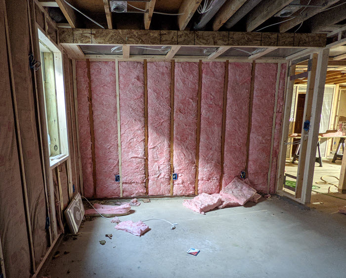 Photo of wood framing and pink insulation that will someday be Carol's office