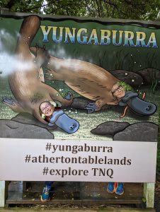 Photo of a sign with an illustration of two platypuses, with cutouts to encourage tourists to take funny photos. 