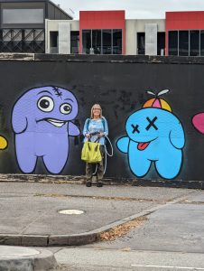 Photo of Carol's friend Nancy standing in front of a mural in Melbourne during their great Aussie adventure.