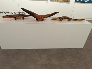 Photo of three wood carvings of lizards by indigenous artists of Central Australia