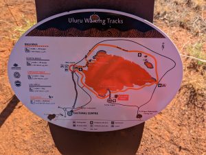 Photo of a sign with a map and information about walking trails at Uluru in Central Australia